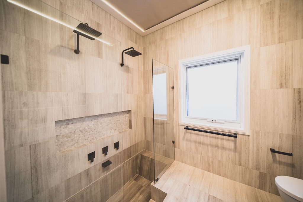 an open shower with a glass door